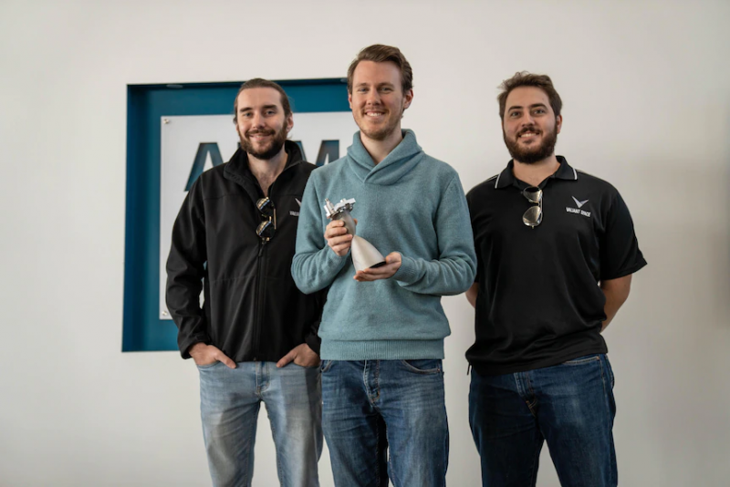 Three Valiant team members, including CEO Andrew Uscinski holding thruster and valve