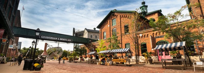 People walking on the cobblestone laneways by the boutiques, galleries, cafés and restaurants of the historic Distillery District in downtown Toronto, Canada